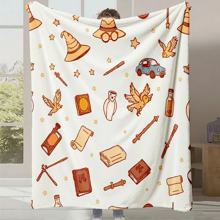 Une couverture blanche ornée de motifs rétro orange représentant divers objets et animaux liés à la nature et aux voyages, créant une atmosphère chaleureuse et nostalgique.