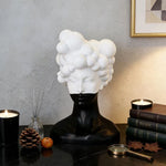 statue tête noire blanche texture mat moderne abstraite bougie concombre loupe livres lampe
