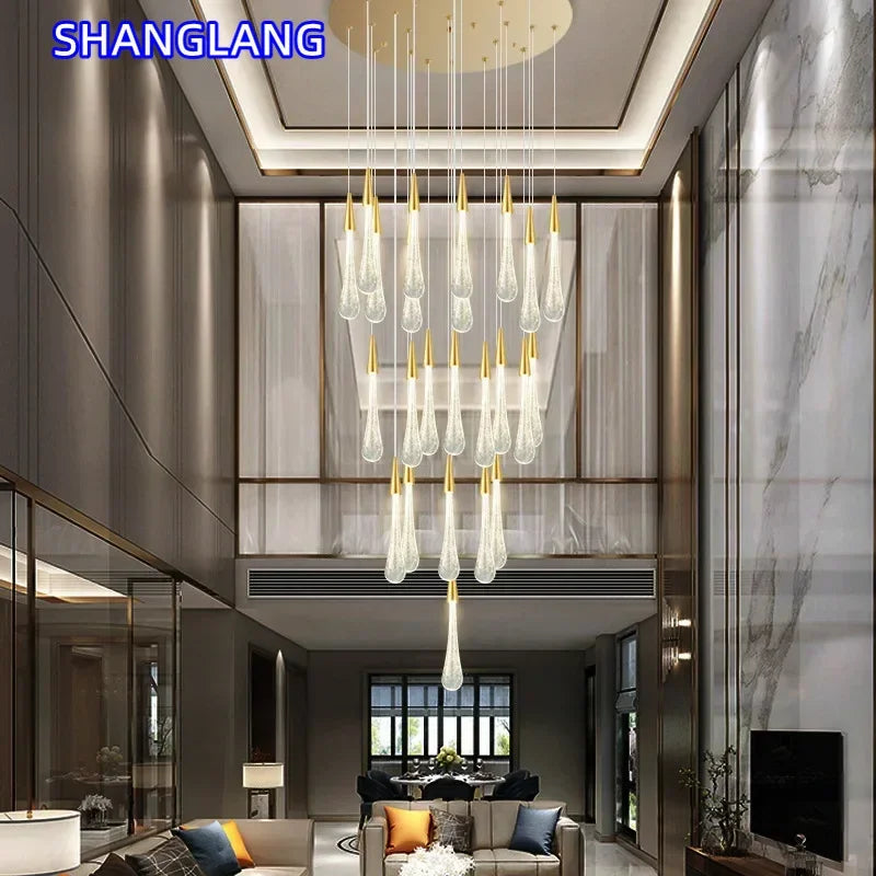 suspension lumineuse moderne gouttes cristal transparentes dorées élégante led acier inoxydable