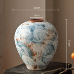 vase artisanal bleu blanc marron marbré rustique arrangement floral branches fruits decoration intérieure
