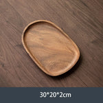 assiettes bois marron clair feuilles modernes métalliques thé tasses théière fruits noix
