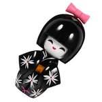 Poupée kokeshi traditionnelle japonaise noir jaune fleurs blanches rose.Points rouges noeud traditionnelle maisonDecoration
