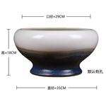 Bol de céramique de design moderne aux couleurs contrastées, avec des nuances de blanc, de marron et de bleu, d'un diamètre d'environ 35 cm et d'une hauteur de 18 cm.