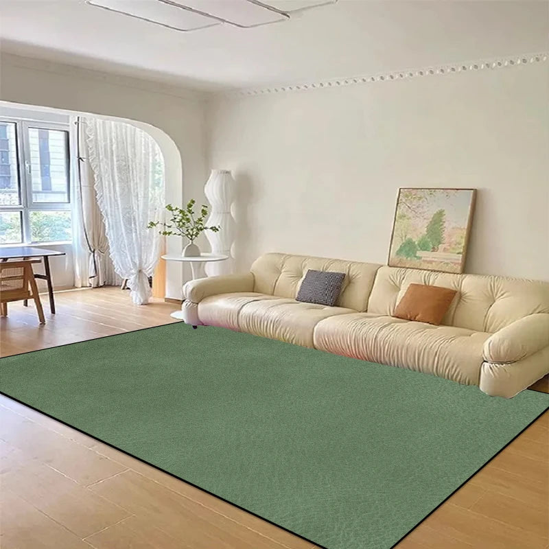 Un beau salon avec un grand canapé beige et un tapis vert qui s'harmonise avec les décorations et l'espace lumineux.