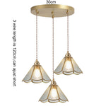 suspension lumineuse verre teinté art deco or marron bleu clair motifs géométriques opacité chaînes