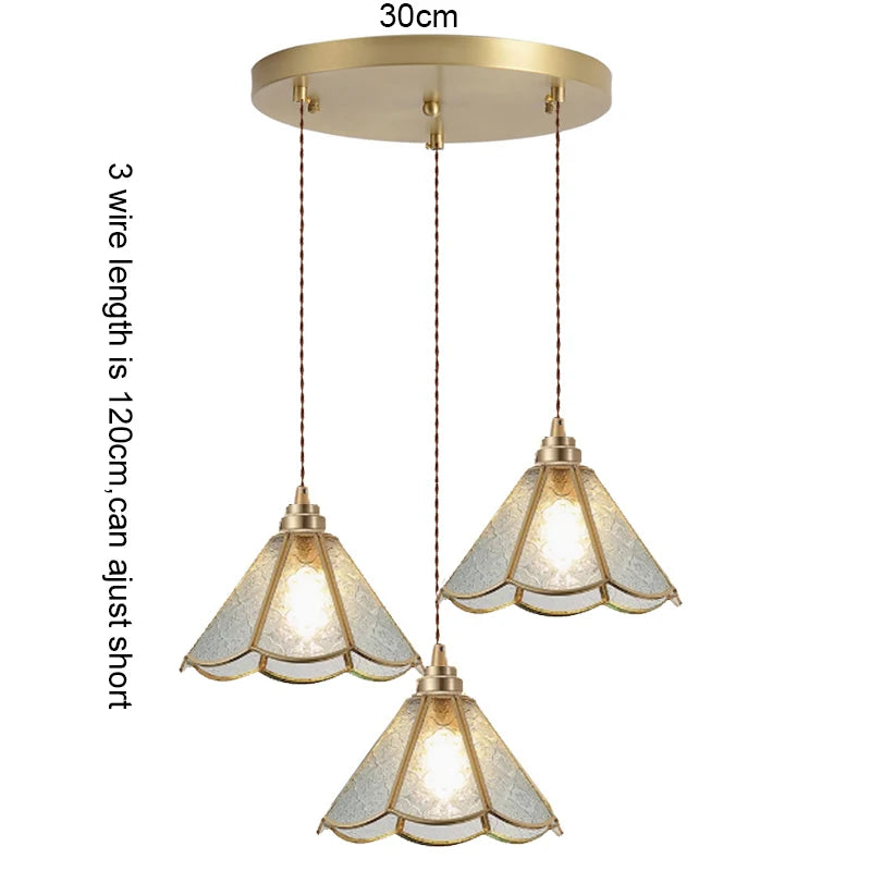 suspension lumineuse verre teinté art deco or marron bleu clair motifs géométriques opacité chaînes