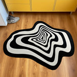 tapis noir blanc moderne abstrait rayures concentriques effet ondulé salon intérieur