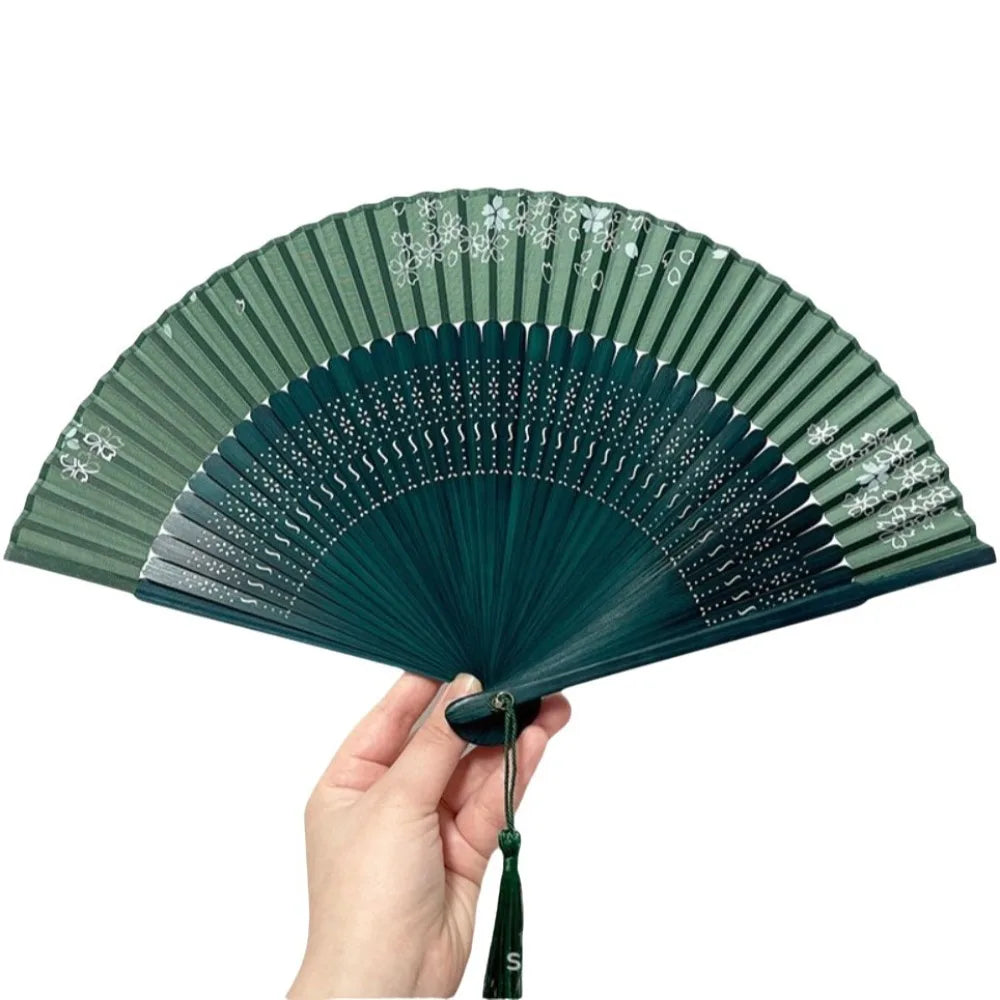 éventail traditionnel rose clair vert noir rayures géométriques opacité pliant bambou tissu pompon rouge