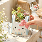 cache pot résine forme chat blanc bleu rose yeux noirs narines roses sourcils noirs