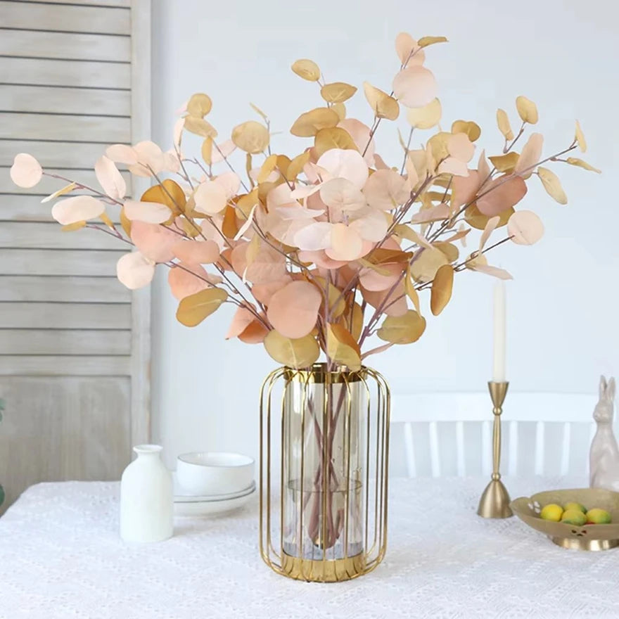 bouquet artificiel feuilles ovales moderne vase transparent support doré couleurs vives exposition intérieure