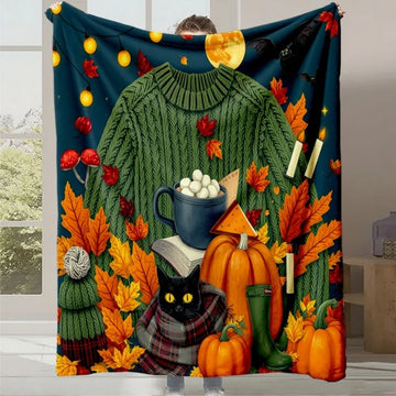 Un plaid douillet avec une image d'automne colorée et chaleureuse, représentant des feuilles, citrouilles, un chat noir et divers accessoires de la saison.