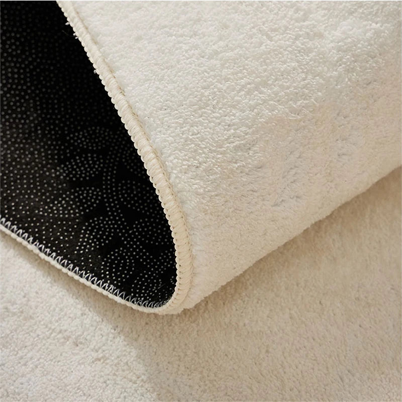 Motif géométrique noir et blanc sur tapis en fourrure blanche épaisse et douce.