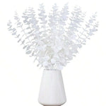 vase blanc moderne fleurs artificielles feuilles vertes décoration table intérieure