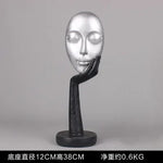 masque sculptural contemporain noir blanc doré finement sculpté base circulaire ornement salon