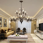 chandelier noir moderne cristaux transparents ampoules blanc chaud suspension élégante branches floralesstylisées