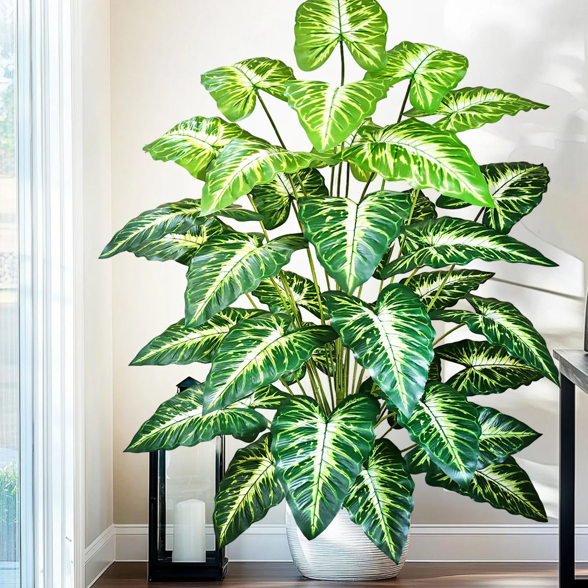 plante artificielle moderne arbre monstera feuilles vertes decoration intérieure pot blanc contemporain exposition maison
