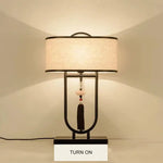 lampe table tissu texturé moderne asiatique pompon abatjour opaque métal noir
