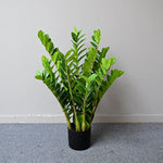 plantes artificielles branches vertes feuilles simples extérieur moderne pot blanc exposé