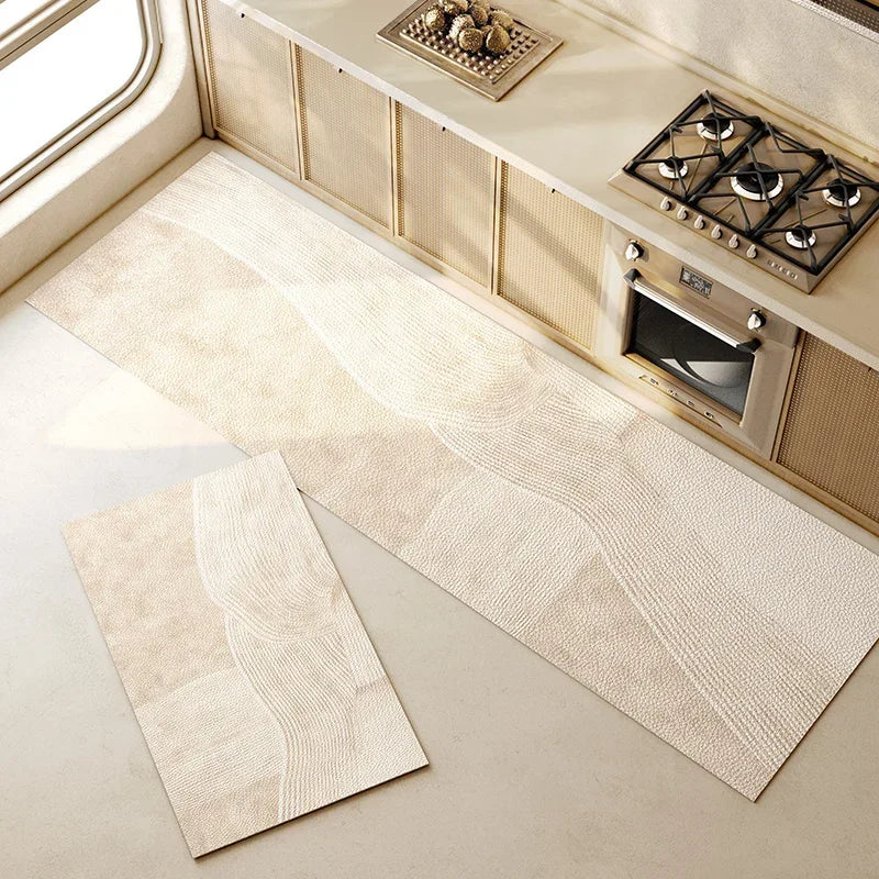 Intérieur de cuisine moderne avec carrelage beige et équipements électriques encastrés.