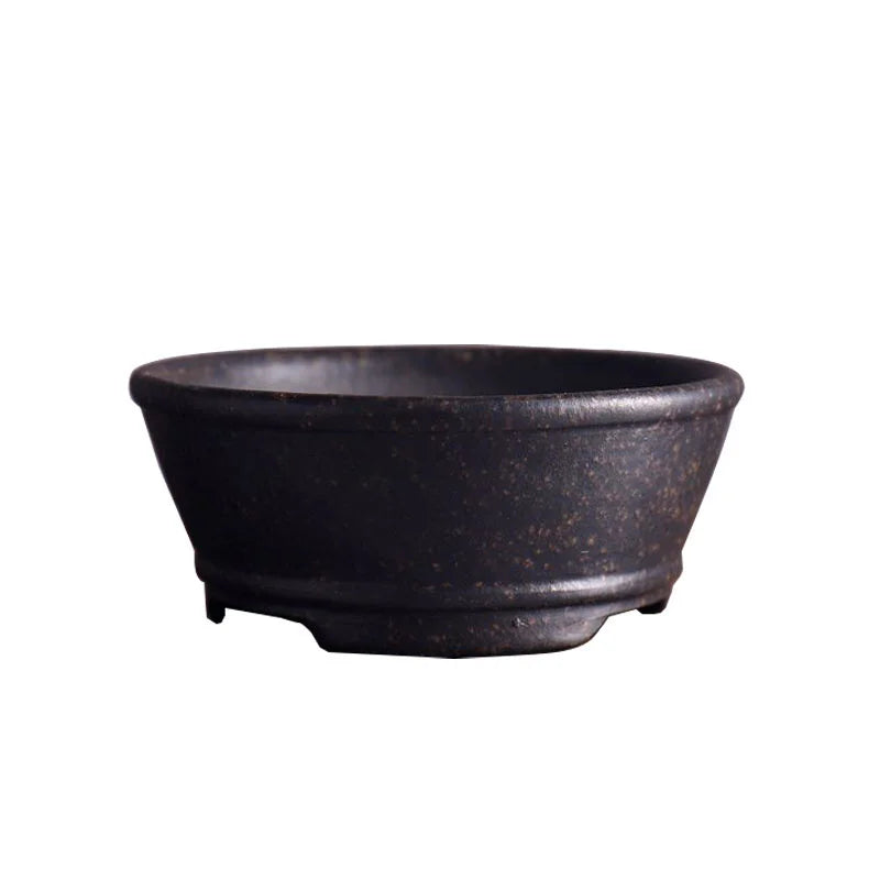 cache pot céramique noir classique motif lignes verticales finition glacé plante verte table decoration