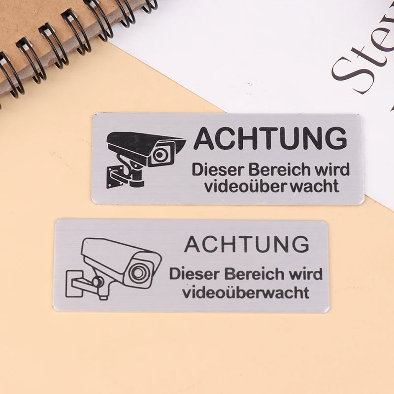panneau signalétique argenté achtung surveillance vidéo adhésif caméra texte avertissement graphique simple porte