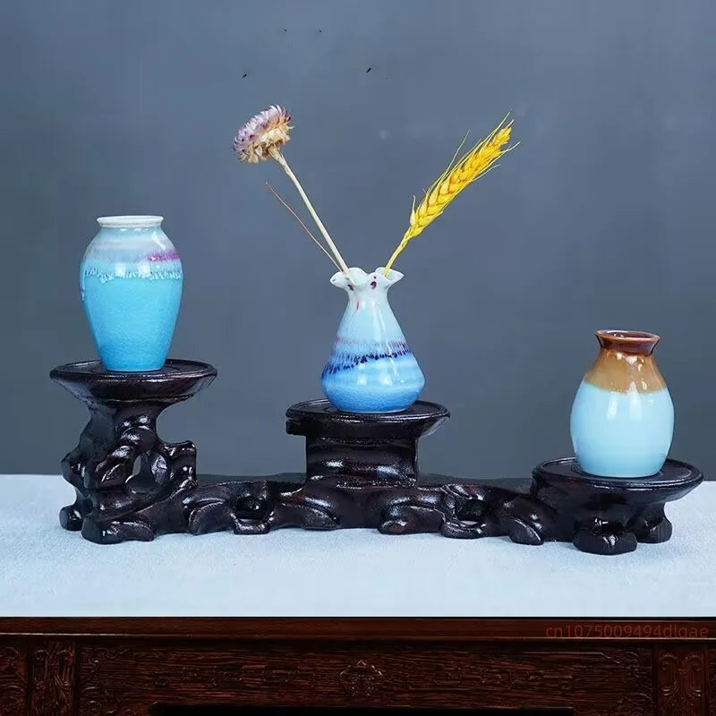 présentoir bois sculpté chinois plateformes circulaires vases céramique fleur séchée bouddha pierre