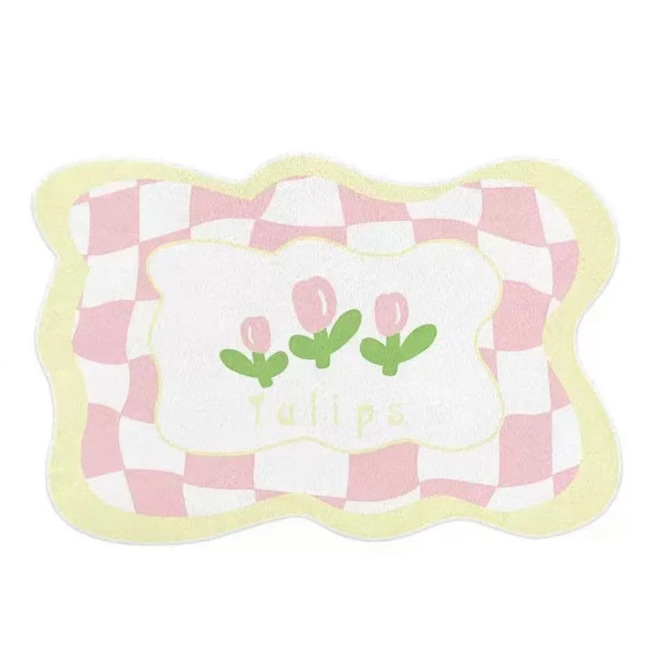 Coussin décoratif carrelage rose et blanc avec fleurs stylisées.