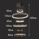 chandelier suspendu moderne plusieurs niveaux anneaux cristal transparents noir doré