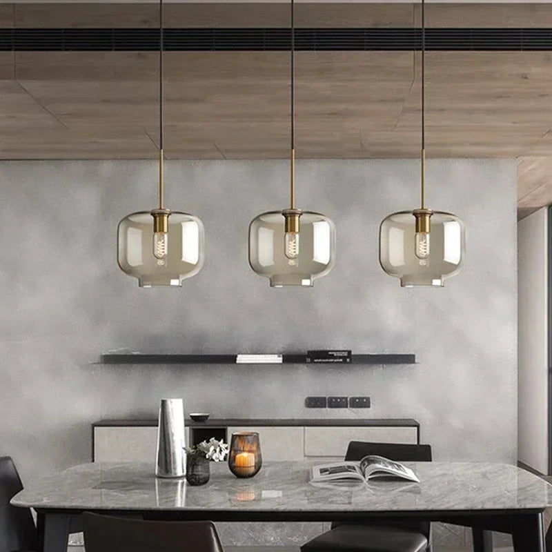 Lampe suspendue en verre clair éclairant une chambre à coucher élégante