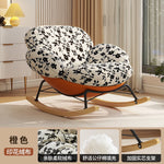 fauteuil bascule moderne beige noir orange roulettes coussin repos minimaliste salon