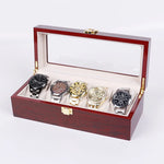 boîtes montres marron foncé compartiments bois luisants poignées dorées classiques organisateur montres luxueuses