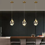 lampe suspendue or transparent cristal facettes géométriques moderne élégante tringles câbles