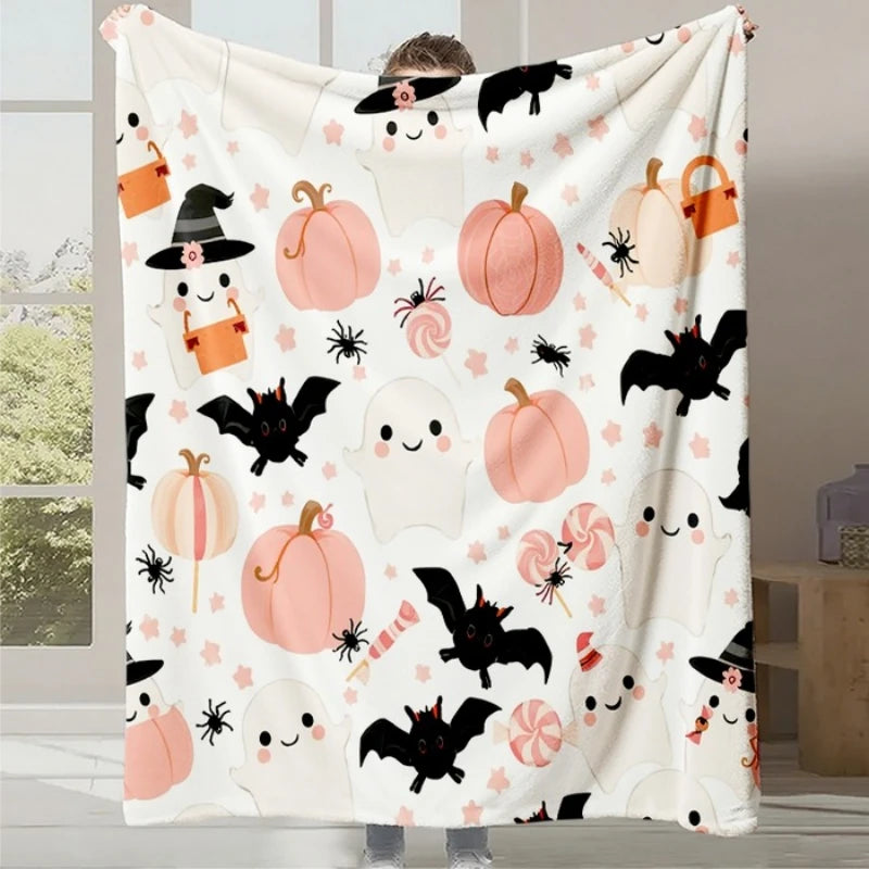 Couverture moelleuse avec des motifs d'Halloween mignons et ludiques, notamment des citrouilles, des fantômes souriants et des chauves-souris noires.