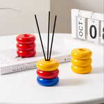 diffuseur huiles essentielles moderne minimaliste rouge jaune bleu noir beige vert géométrique circulaire brillant