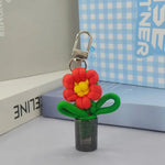 porte clés fleurs tricotées rubans bouteille transparente boucle métal créatif artisanal multicolore
