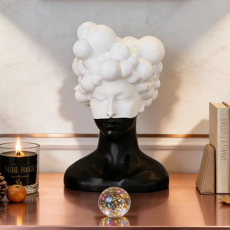 statue tête noire blanche texture mat moderne abstraite bougie concombre loupe livres lampe