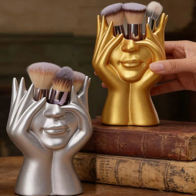 support pinceaux maquillage or argent noir visage stylisé moderne sculpturaliaux pinceaux