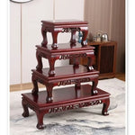 présentoir bois sculpté marron motifs complexes reliefs plantes bonsaï vases fleurs théière tasses déco