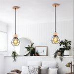 suspension lumineuse industrielle cage métal finition bois naturel ampoule filament noir moderne