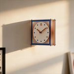 horloge murale double face moderne cadre transparent bleu orange aiguilles marron cadran blanc points