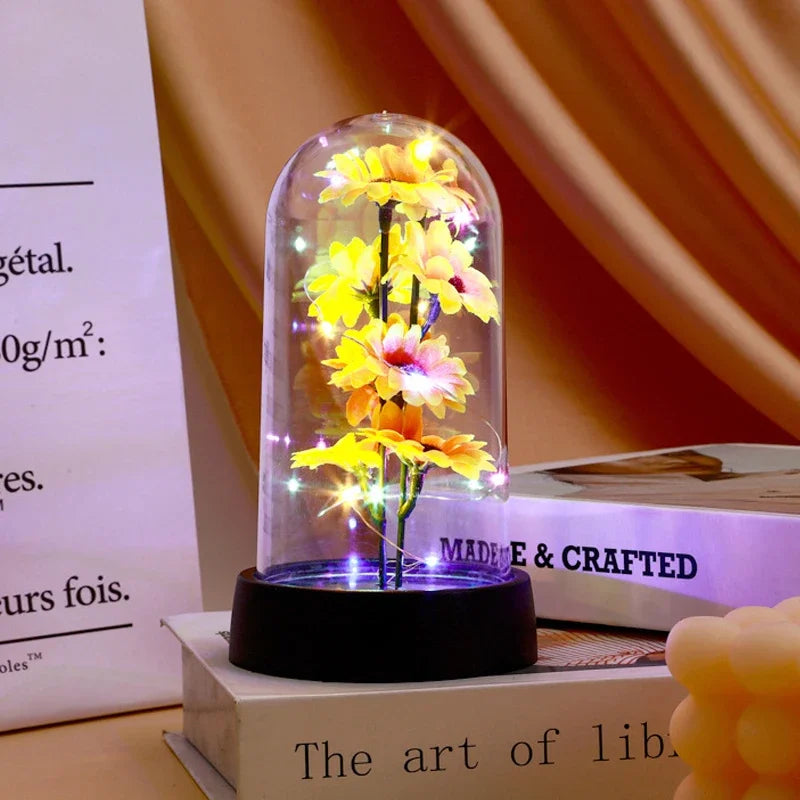 décoration florale cloche verre fleurs jaunes tige verte base noire guirlande led lumineuse romantique
