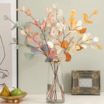 bouquet artificiel feuilles ovales moderne vase transparent support doré couleurs vives exposition intérieure