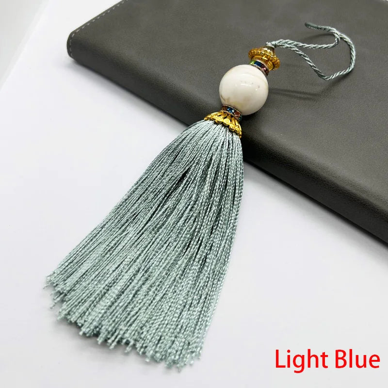 pompon décoratif gris bleu doré vert violet tissu finement tressé élégant moderne blanche chaîne