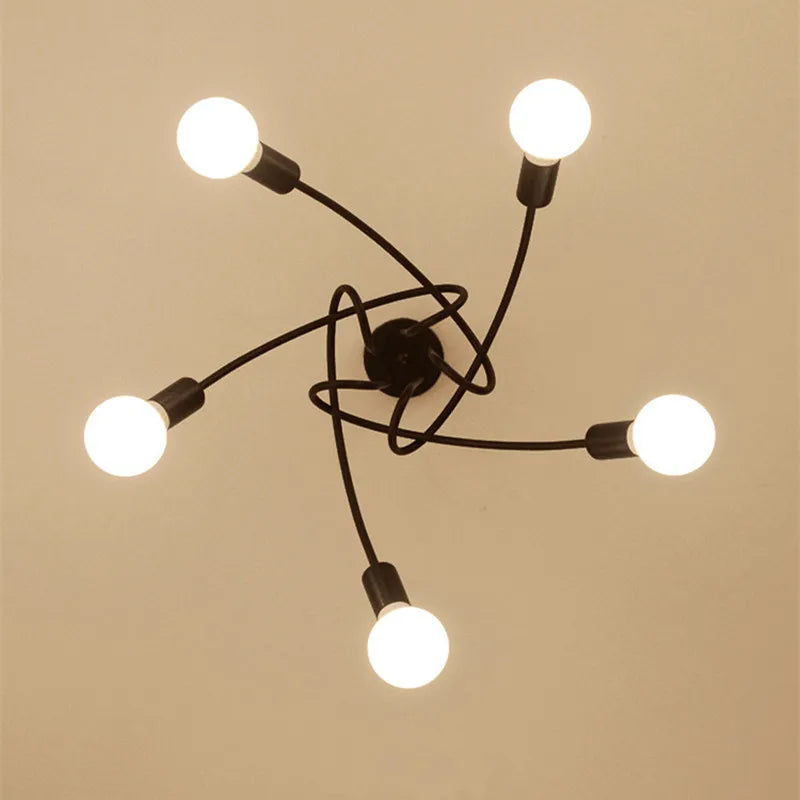 suspension lumineuse moderne noir doré ampoules blanches structure spirale fixation câbles métallique