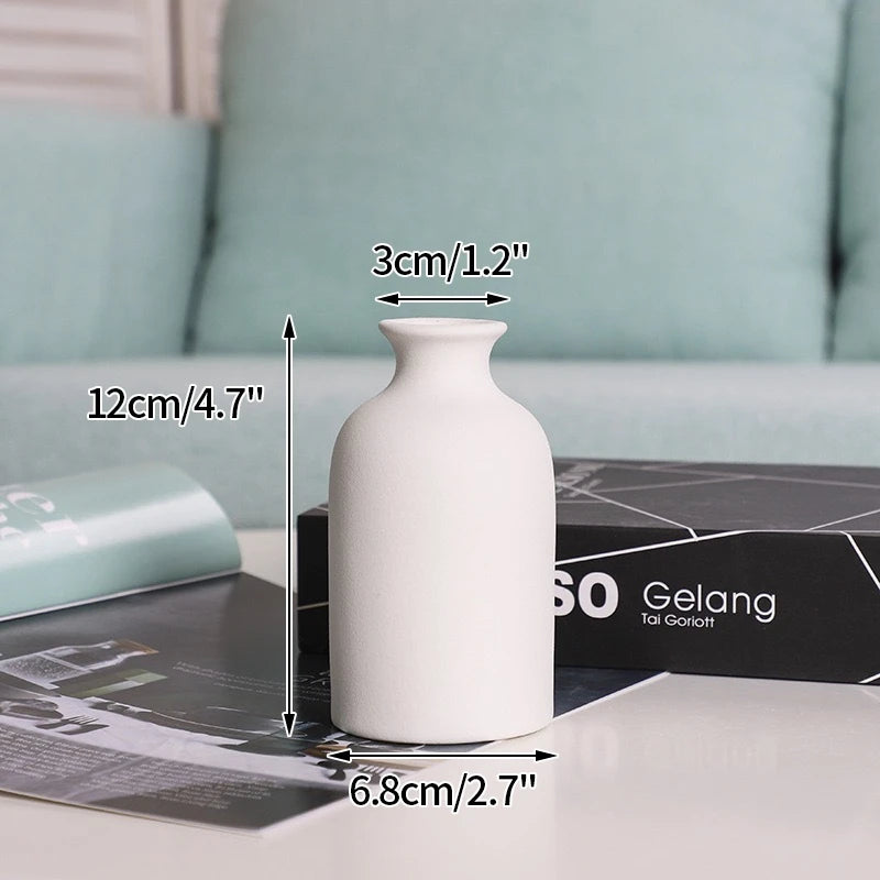 vase céramique blanc minimaliste décoration maison fleurs séchées feuilles vertes pomme pin coton bougie