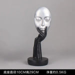 masque sculptural contemporain noir blanc doré finement sculpté base circulaire ornement salon