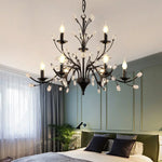 chandelier noir moderne cristaux transparents ampoules blanc chaud suspension élégante branches floralesstylisées