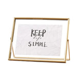 cadre photo moderne minimaliste or noir pieds triangulaires texte simple verre
