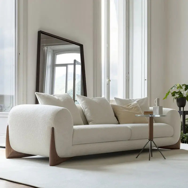 canapé moderne cuir synthétique beige clair coussins tissu bouclé salon familial