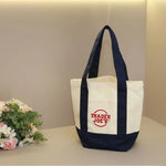 sac main toile verte rouge blanc jaune trader joes logo poignées simple pratique